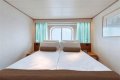 An old Holland America cruise ship is turning residential, letting travelers live at sea for $8,000 a month while it circumnavigates the globe